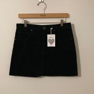 Forever 21 short black corduroy skirt, front zipper Size Large 4 pockets Raw hem